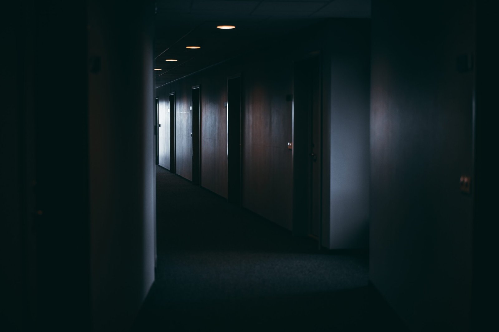 dark-moody-look-down-hotel-motel-hallway-scary-dim-2026-01-07-05-20-07-utc